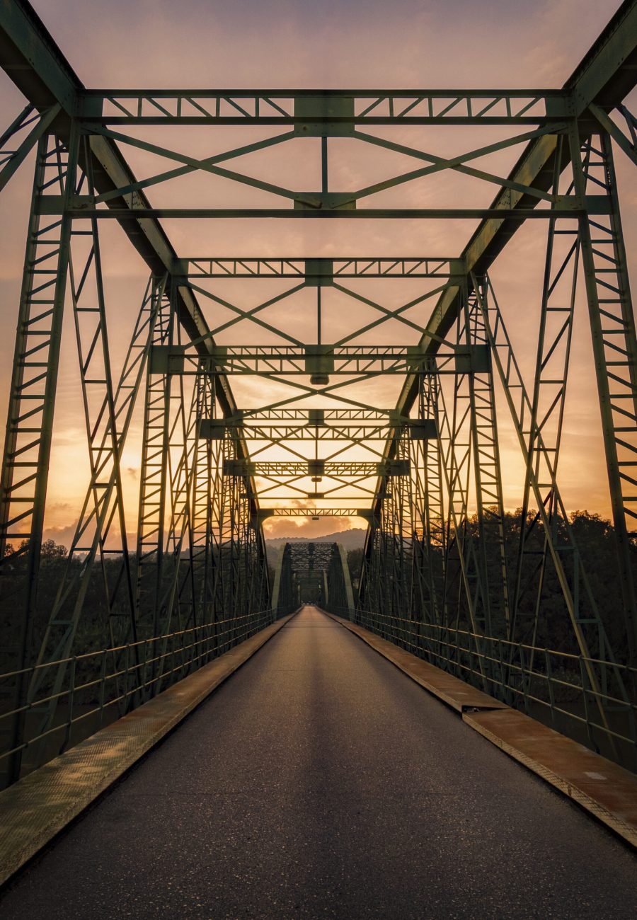A beautiful vertical shot of a bridge at sunset