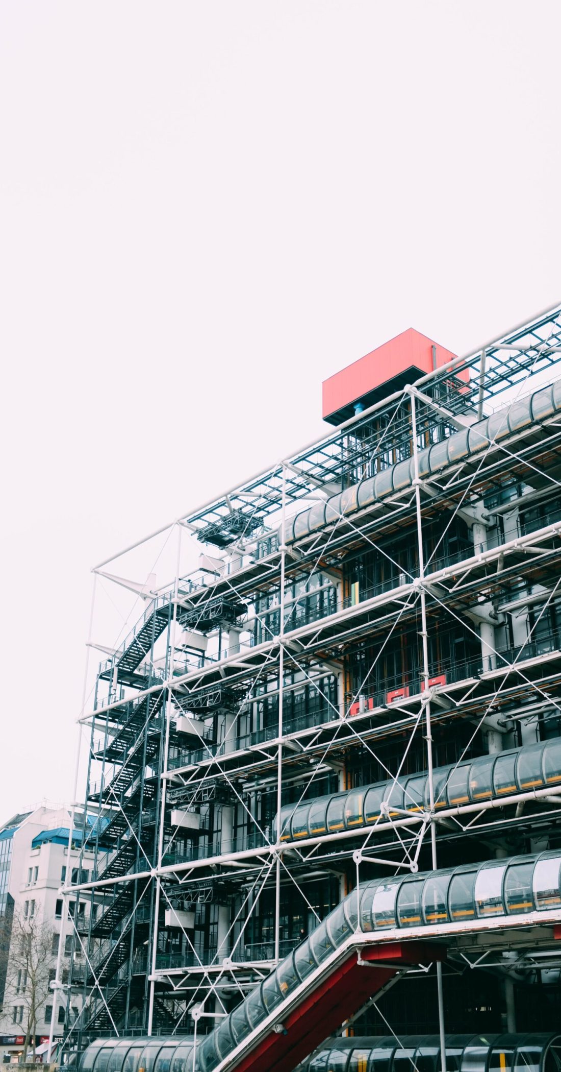A vertical shot of a metal structure under the bright sky